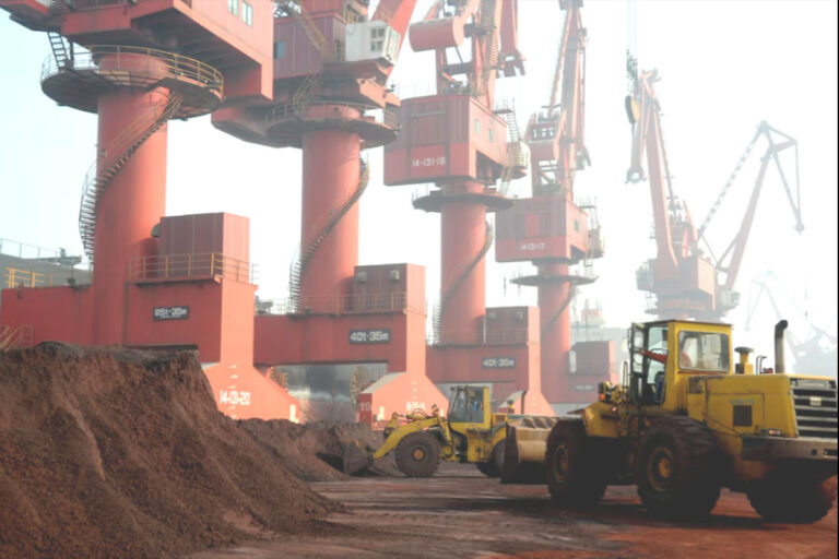 Workers transport soil with rare earth elements as part of global resource geopolitics
