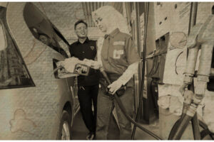 Worker refueling a car at a Jakarta gas station during rising fuel prices linked to Strait of Hormuz energy supply risks.